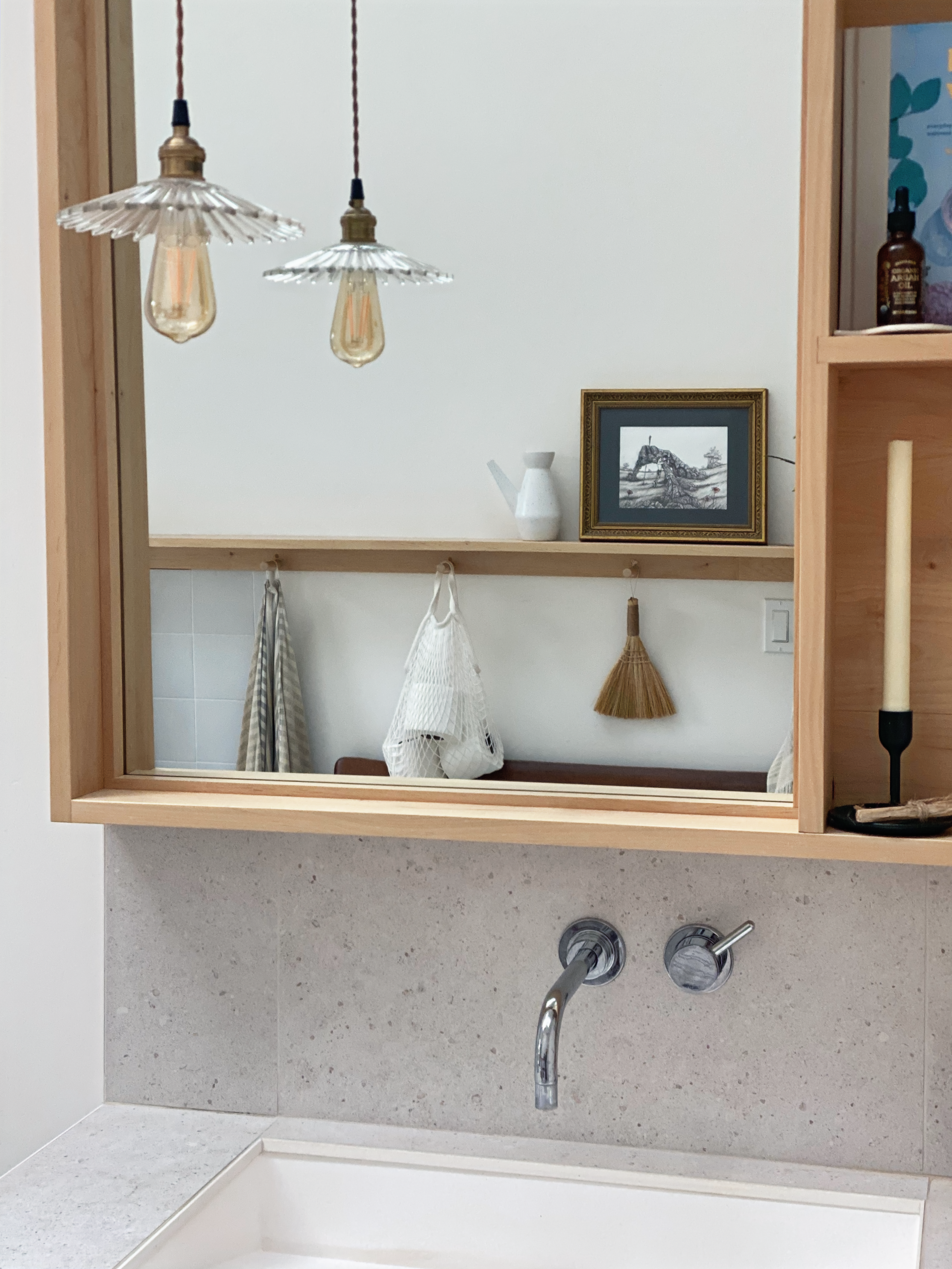 Bathroom vanity and mirror detail with pendant lights