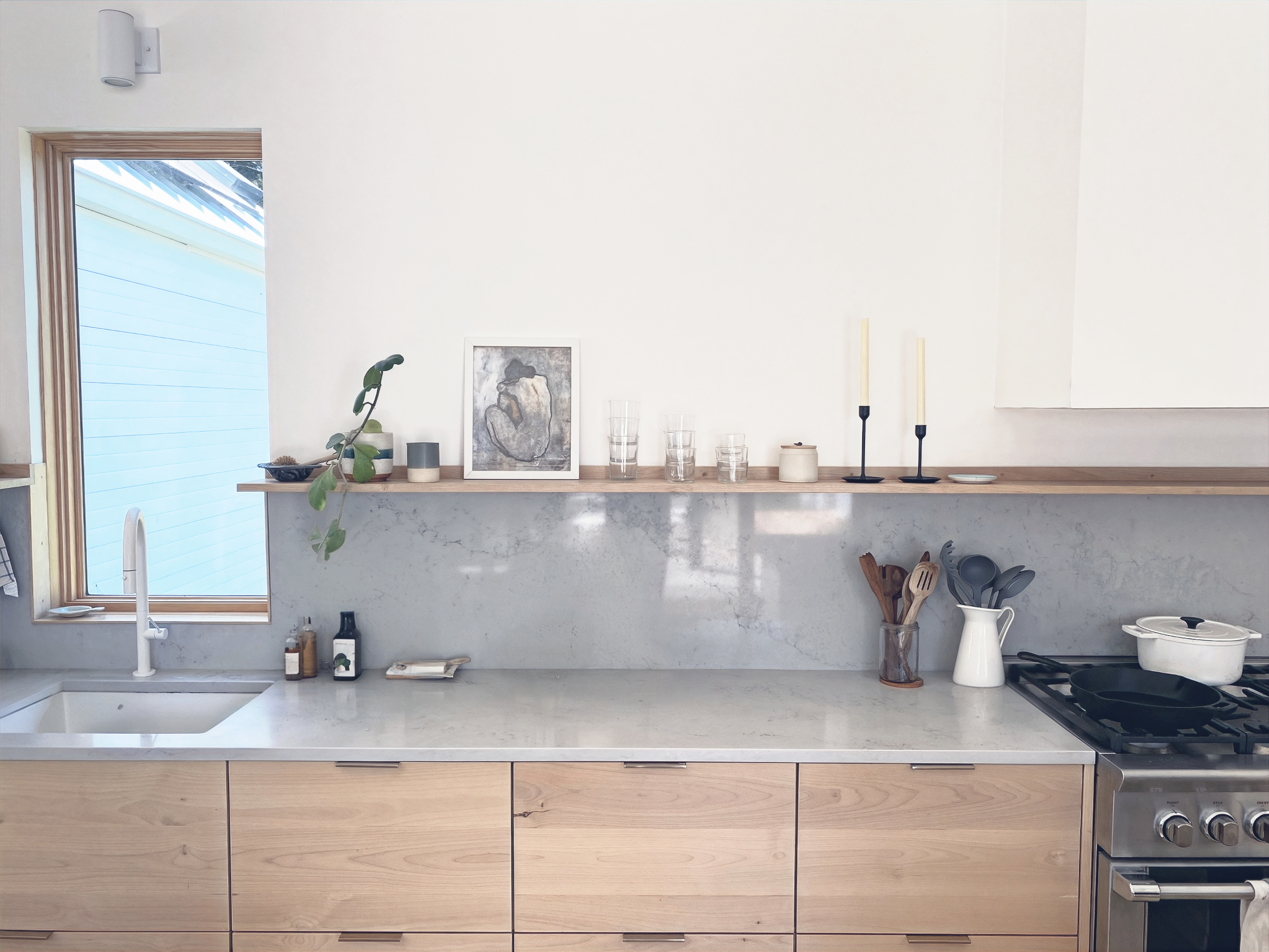 Finished kitchen with wood cabinetry and stone counter