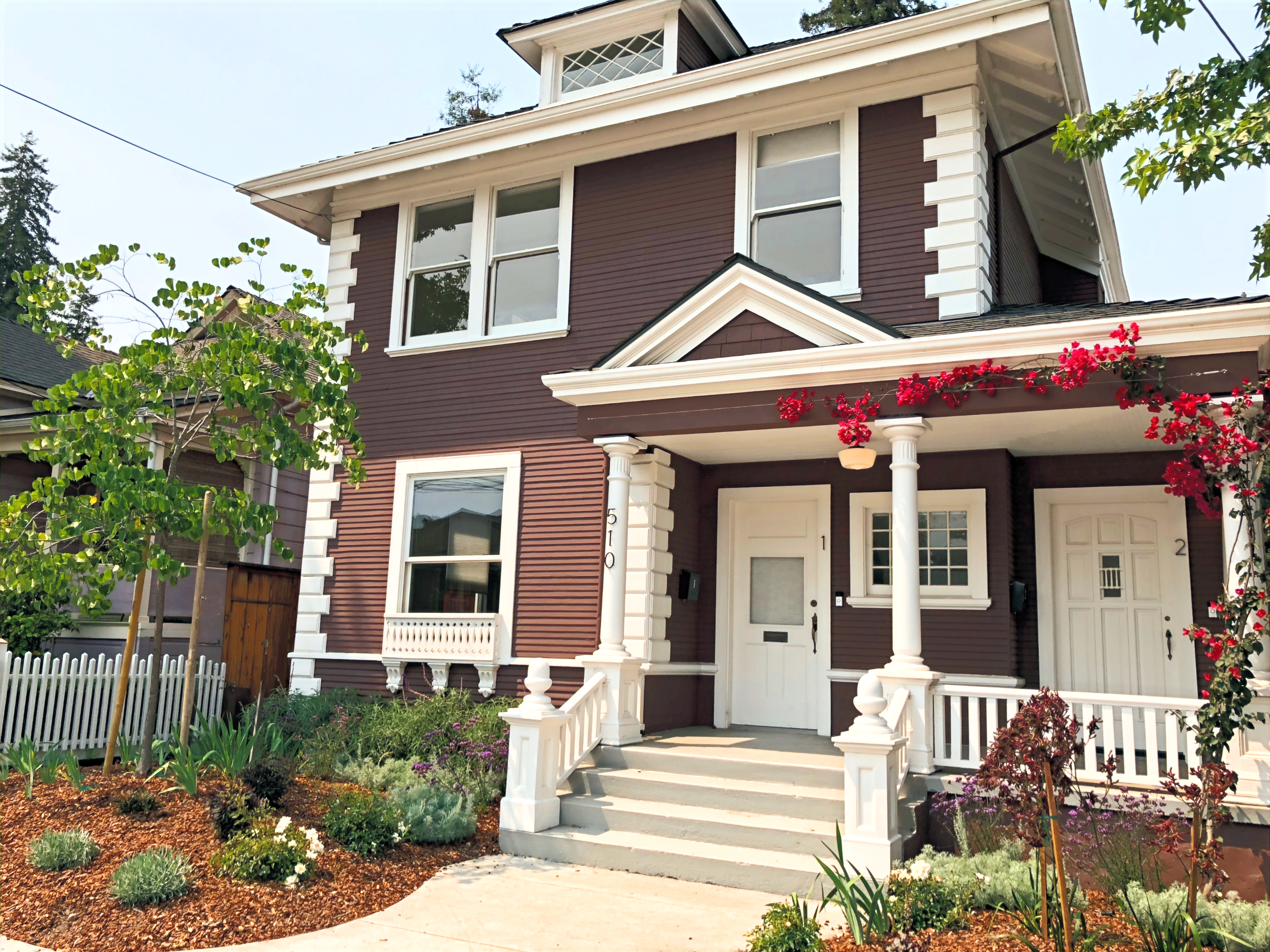 Restored residential exterior with landscaped entry